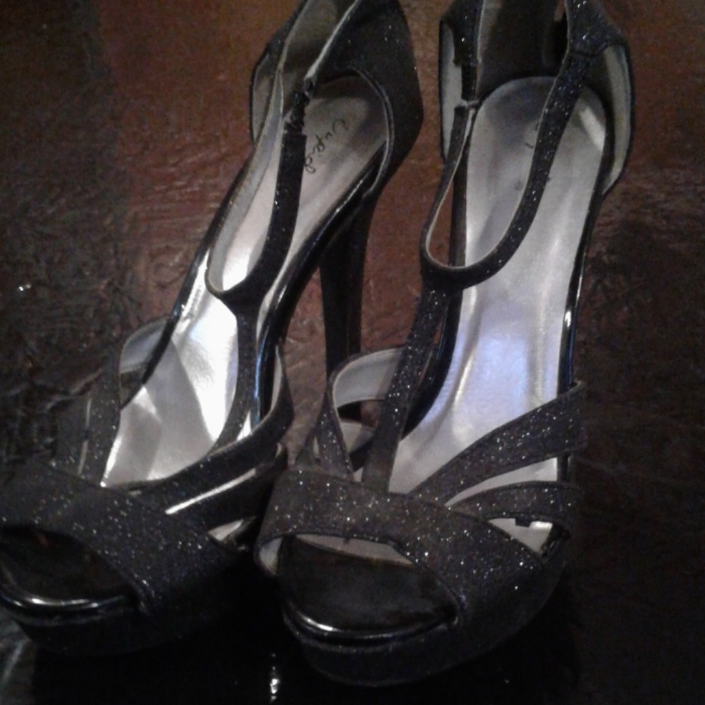 Shimmery black high heels.
